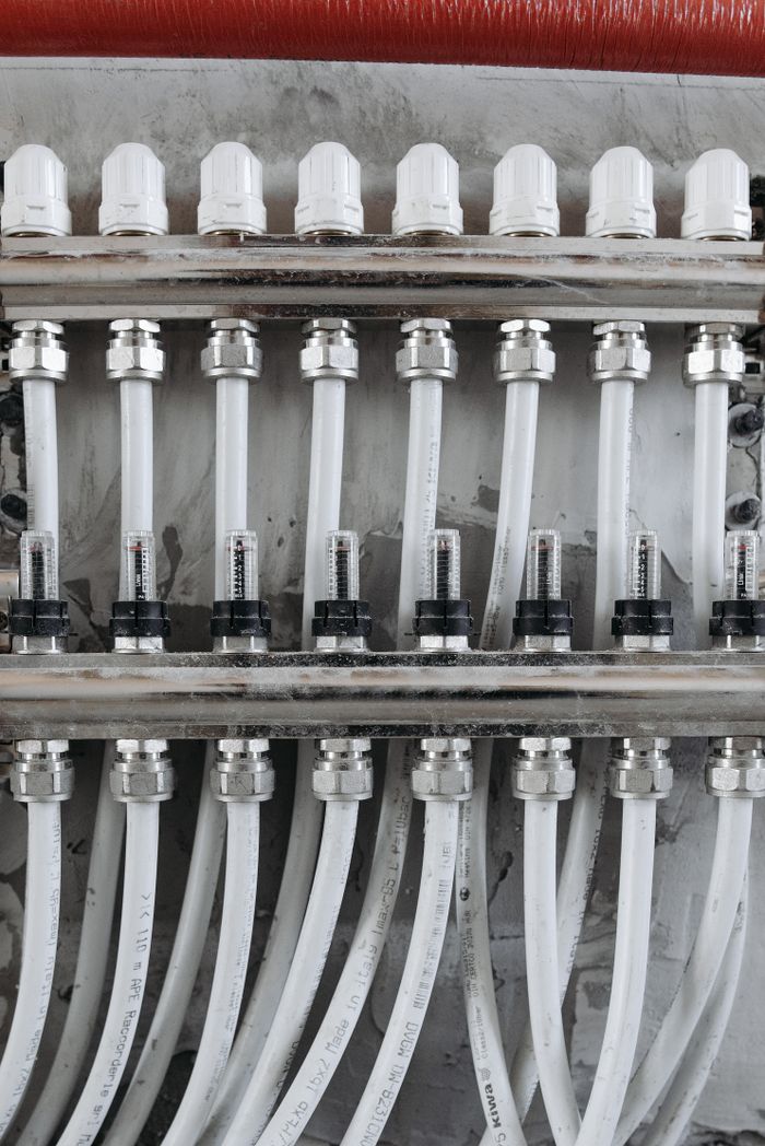 Services Close-up view of an industrial pipe connection system with gauges and valves.